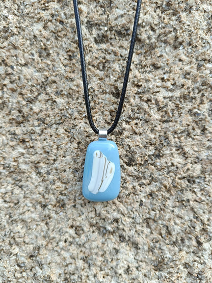 blue and white pendant hangin against a granite wall