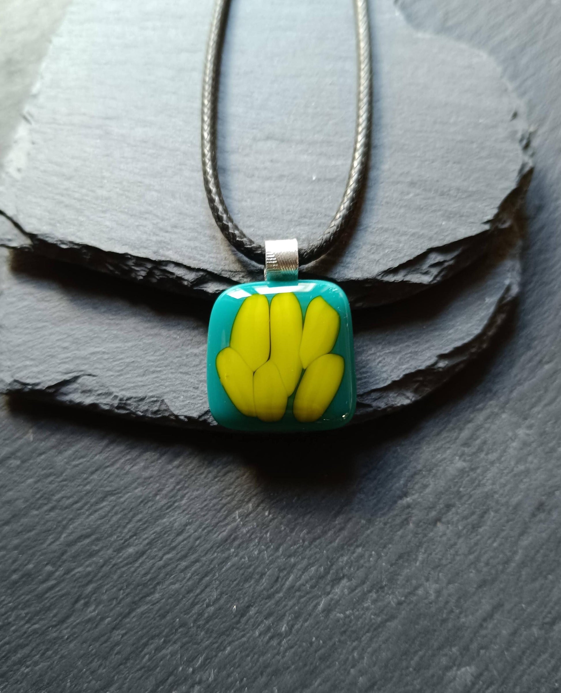 Teal fused glass pendant on a silver cord necklace; turquoise blue glass with yellow shapes, handmade, gender-neutral gift.