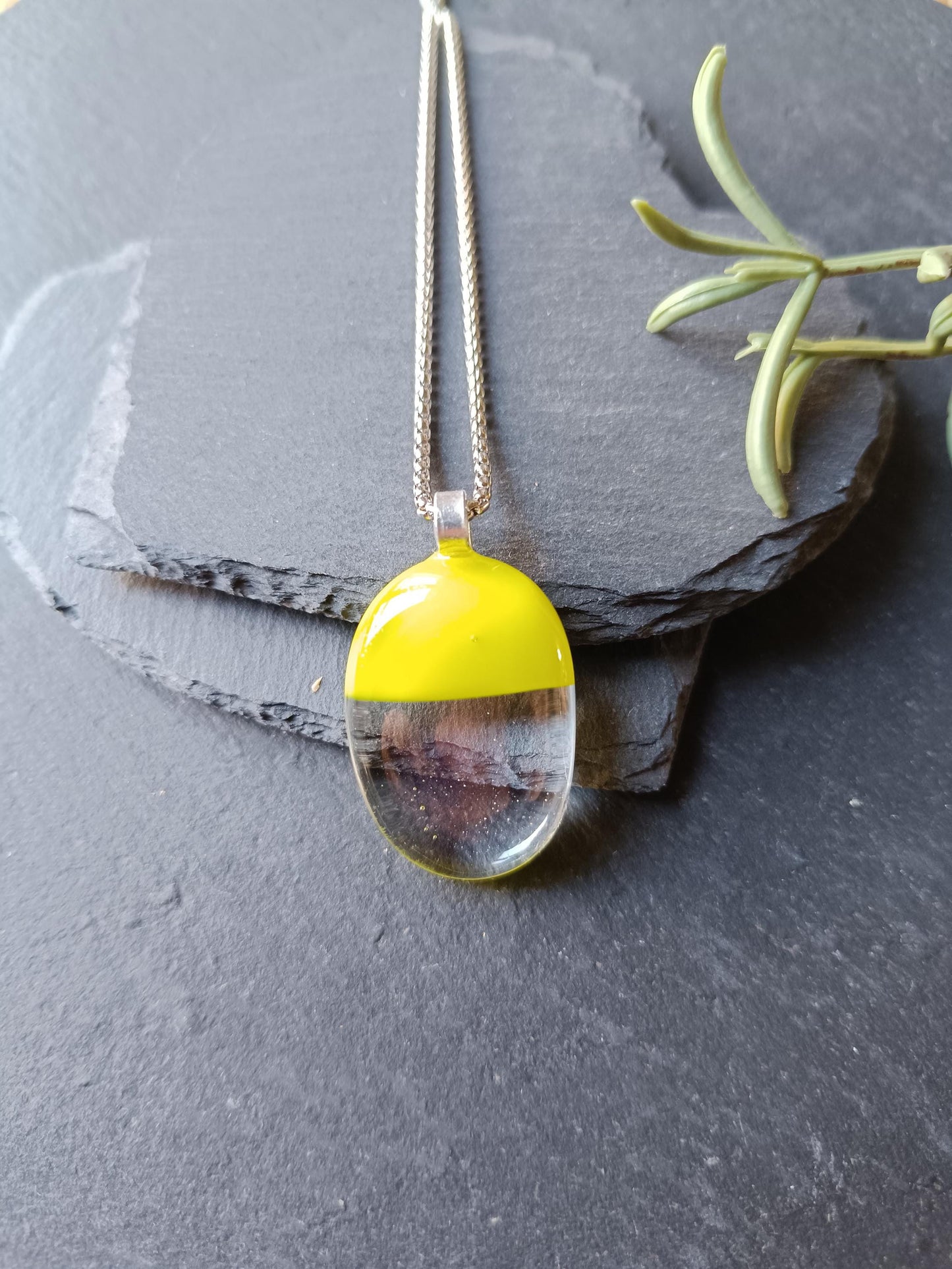 Handcrafted lime green and clear fused glass oval pendant necklace on a silver chain.