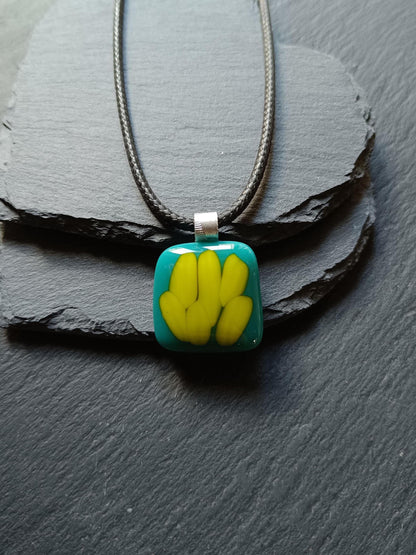 Teal fused glass pendant on a silver cord necklace; turquoise blue glass with yellow shapes, handmade, gender-neutral gift.