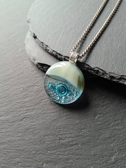 Blue bubble necklace: round fused glass pendant with aqua gradient and bubbles on a silver chain; one-of-a-kind handmade jewellery.