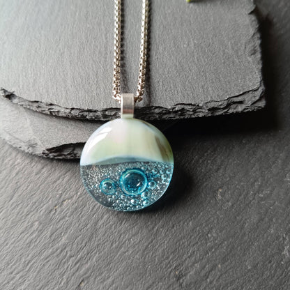 Blue bubble necklace: round fused glass pendant with aqua gradient and bubbles on a silver chain; one-of-a-kind handmade jewellery.