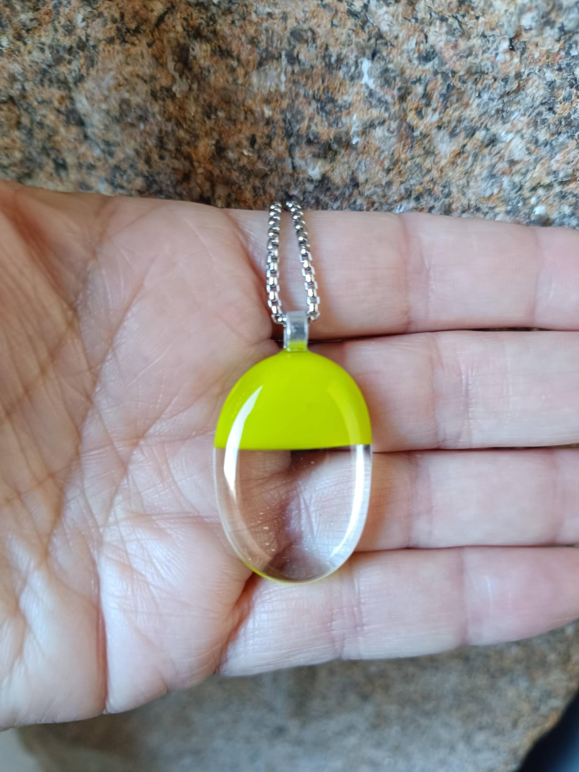 Handcrafted lime green and clear fused glass oval pendant necklace on a silver chain.