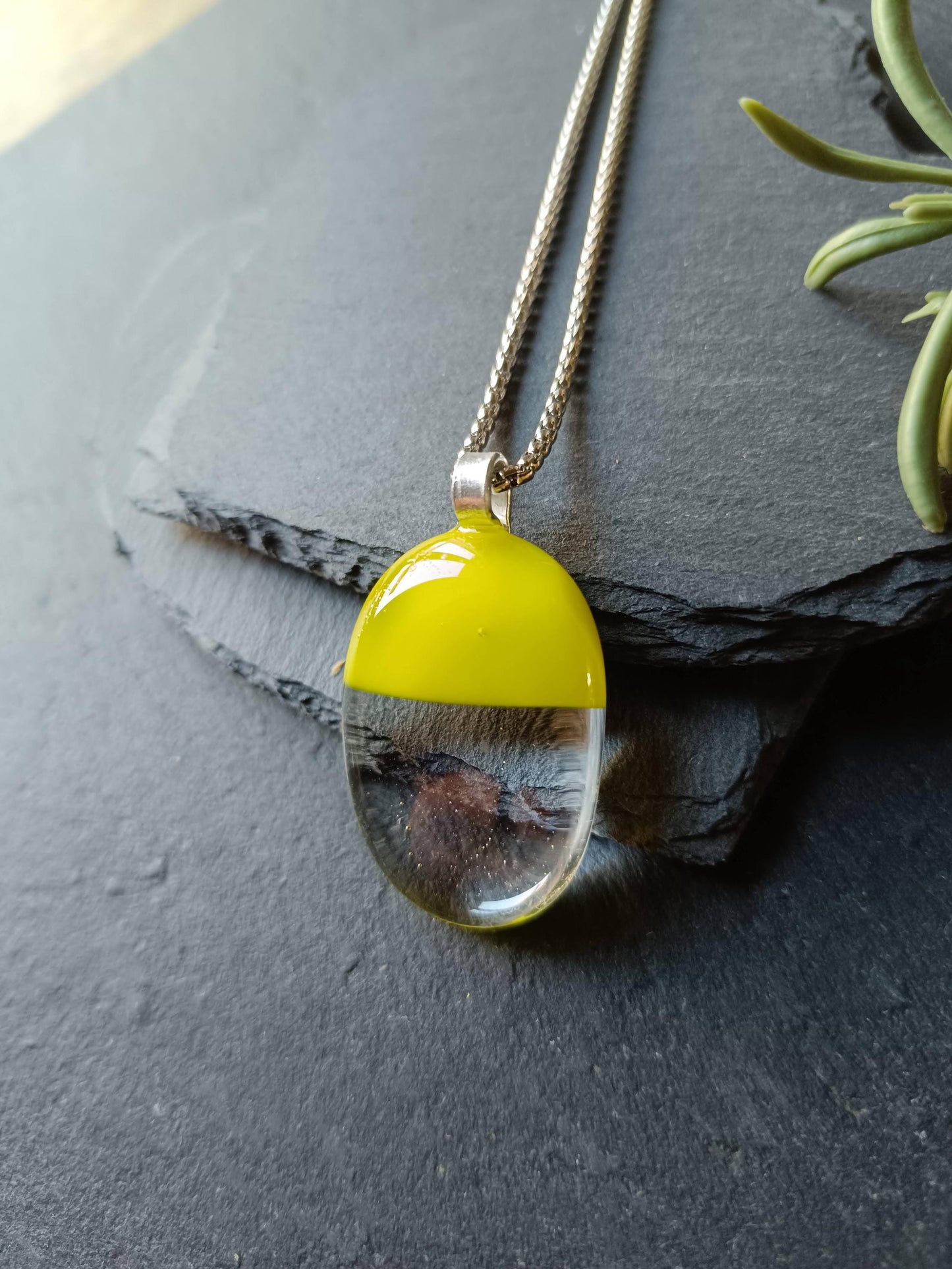 Handcrafted lime green and clear fused glass oval pendant necklace on a silver chain.
