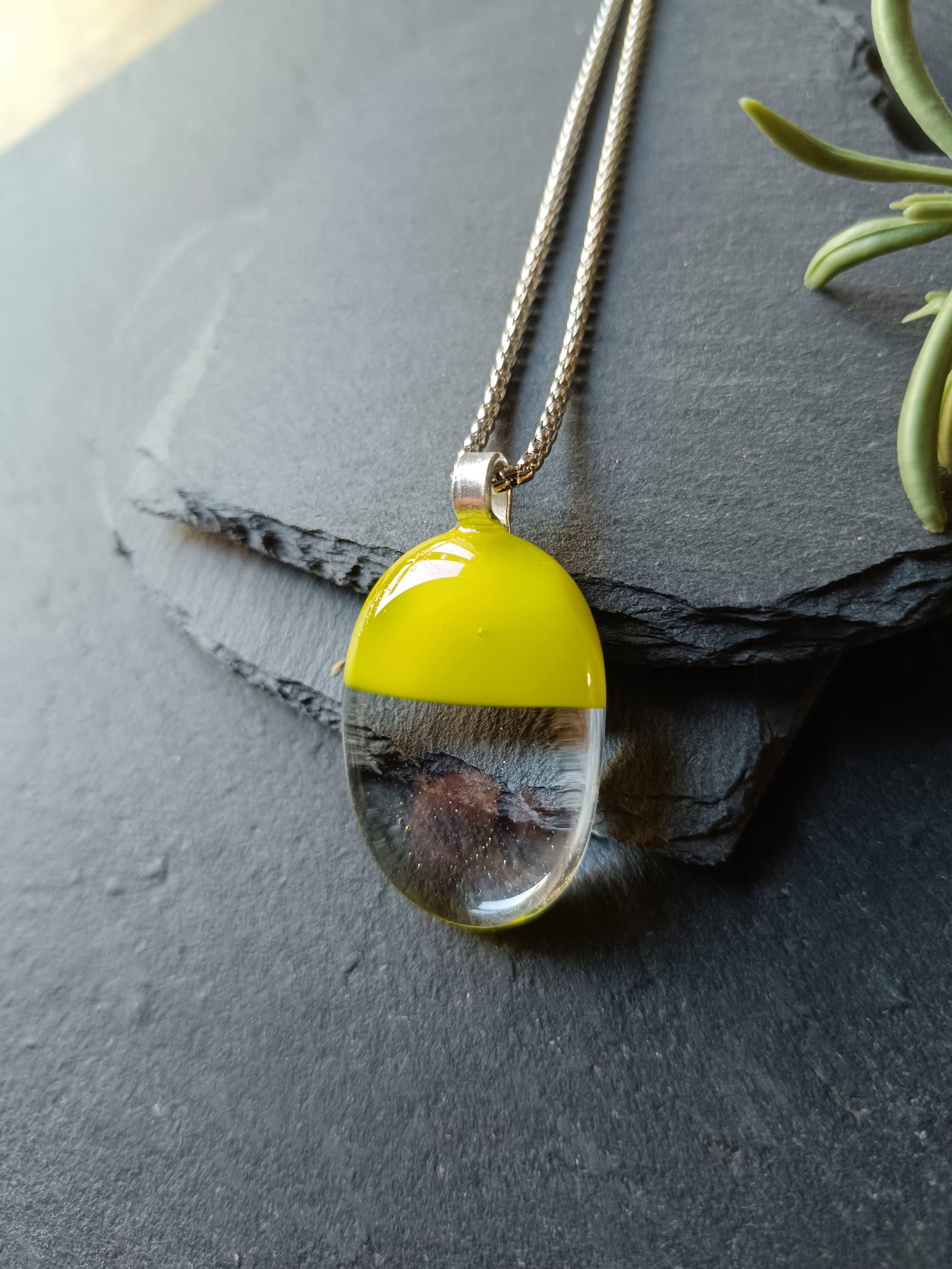 Handcrafted lime green and clear fused glass oval pendant necklace on a silver chain.