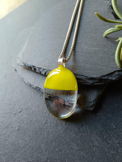 Handcrafted lime green and clear fused glass oval pendant necklace on a silver chain.