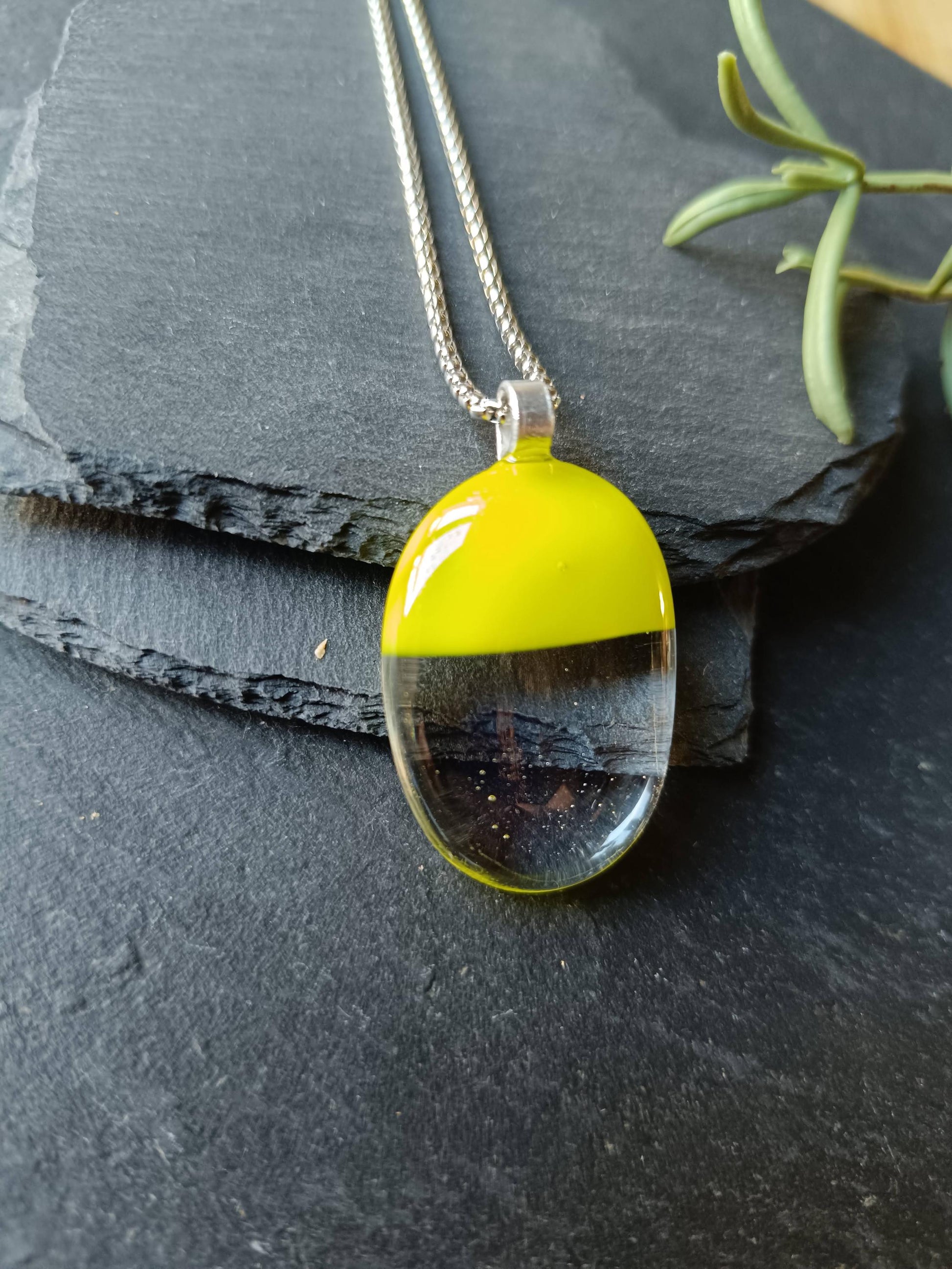 Handcrafted lime green and clear fused glass oval pendant necklace on a silver chain.