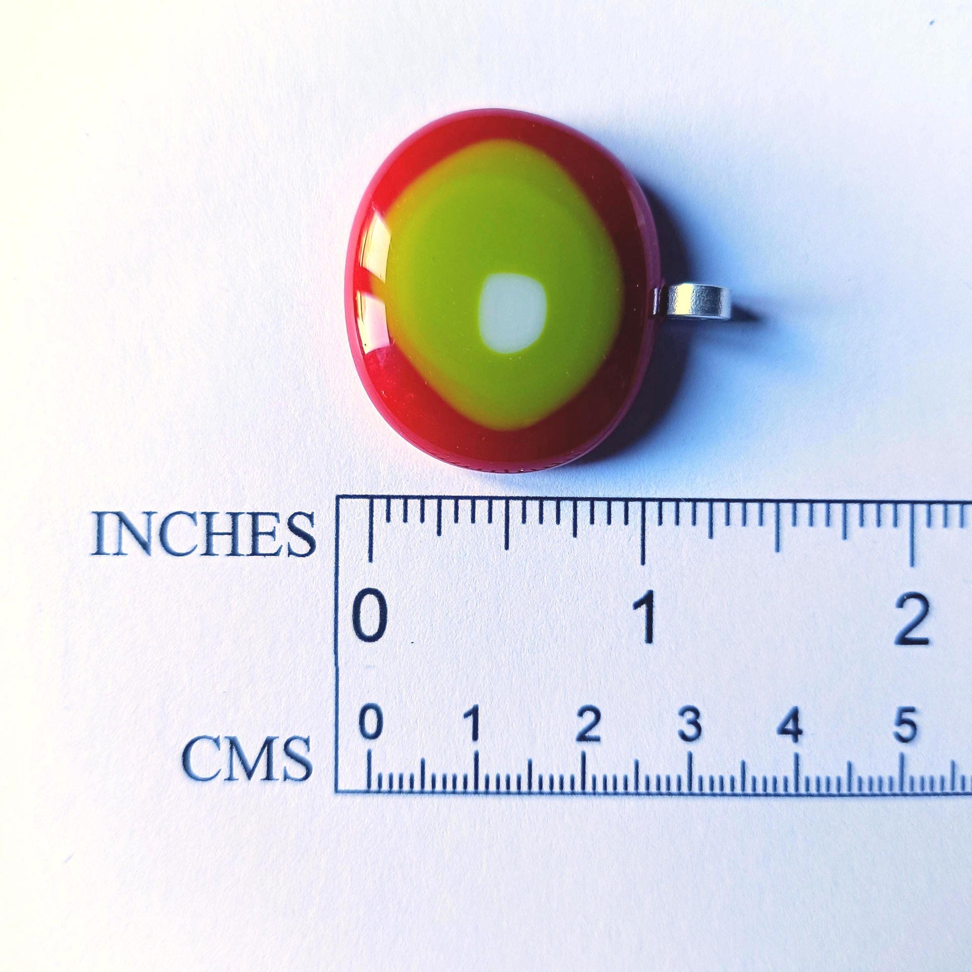 Round fused glass pendant in red, yellow and lime green on a black chain; handmade jewelry, statement pendant.