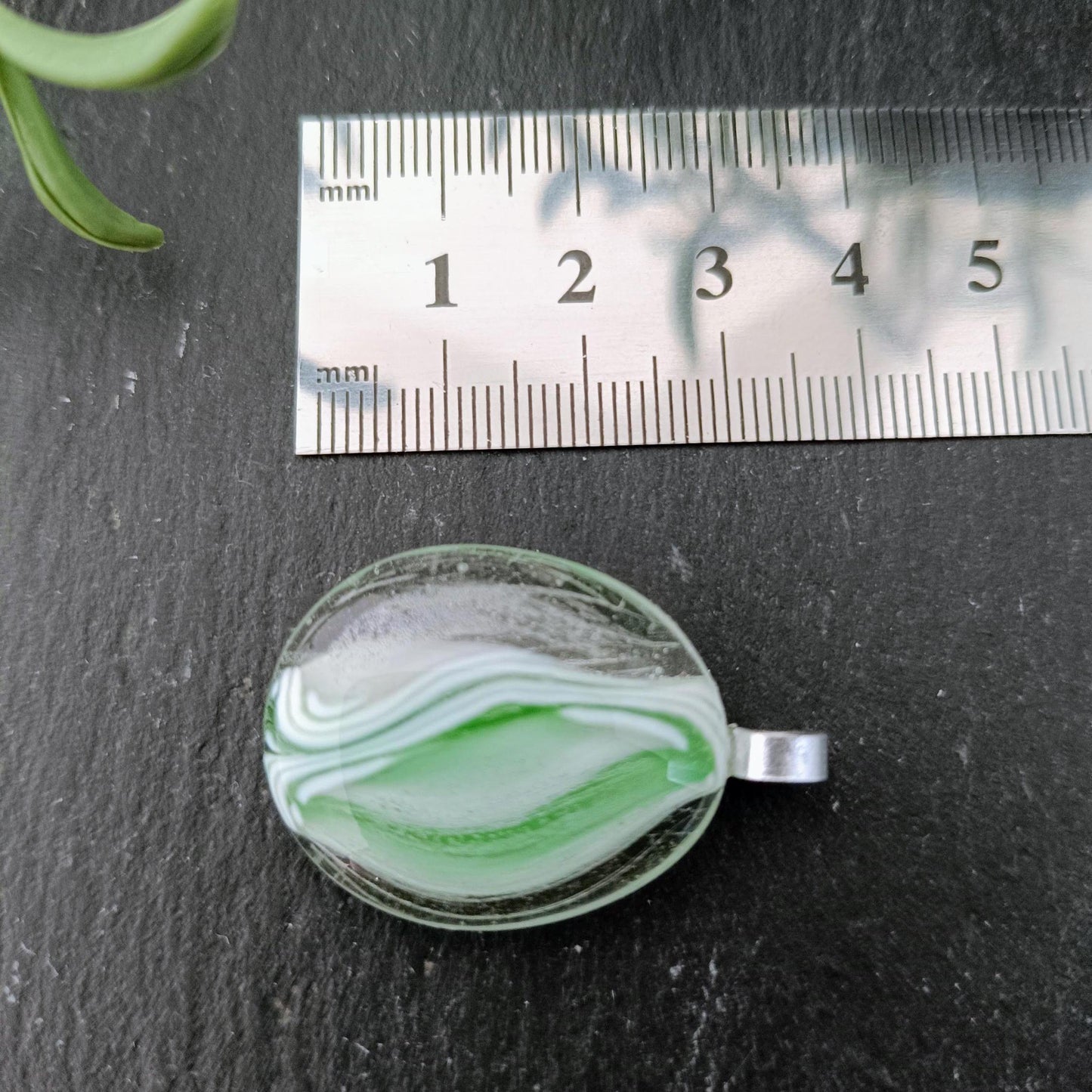 green fused glass pendant and ruler