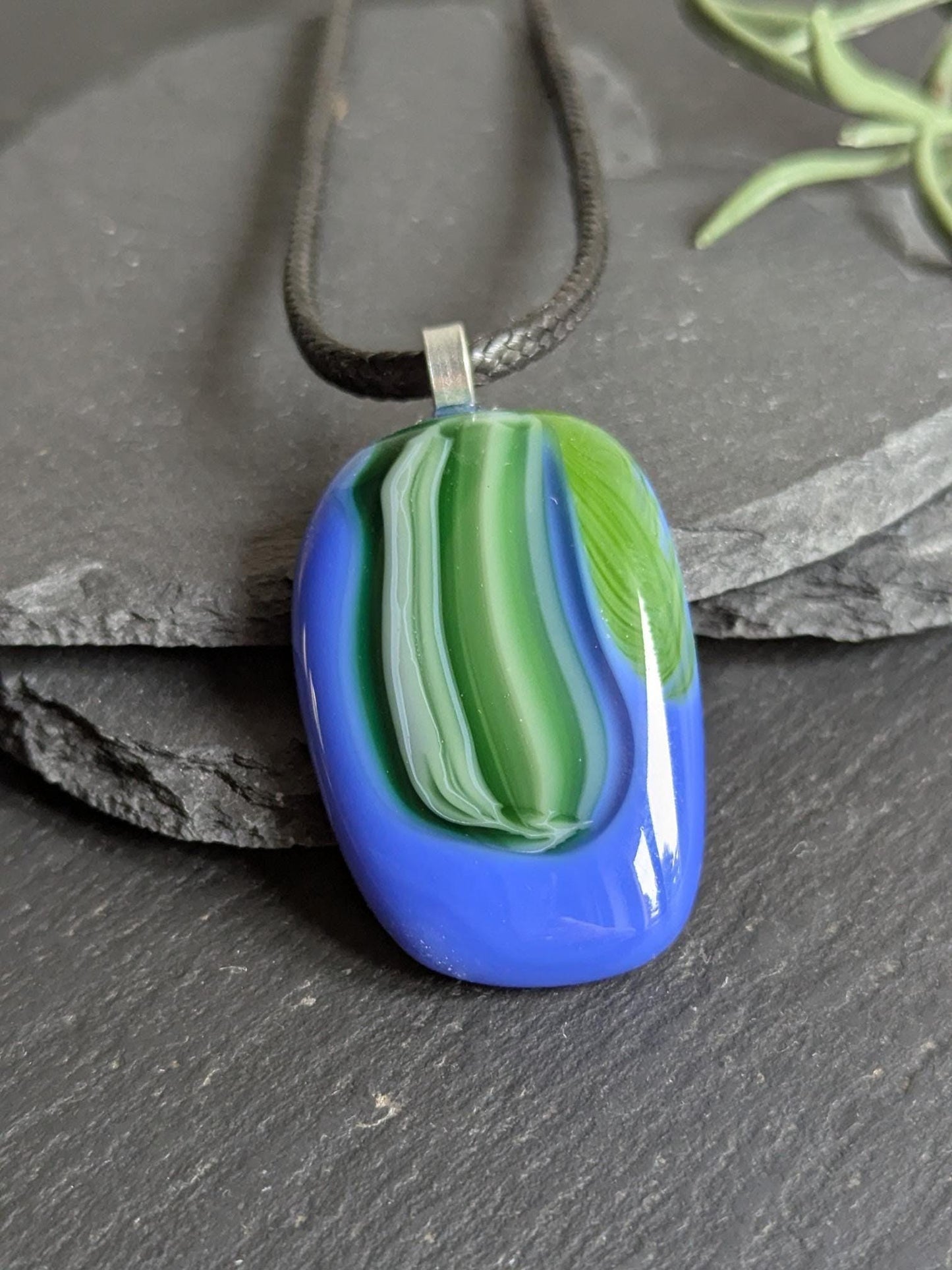 Fused glass pendant on black cord necklace; oval blue pendant with green swirls, handmade jewellery, unique one-of-a-kind.
