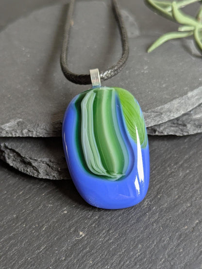 Fused glass pendant on black cord necklace; oval blue pendant with green swirls, handmade jewellery, unique one-of-a-kind.