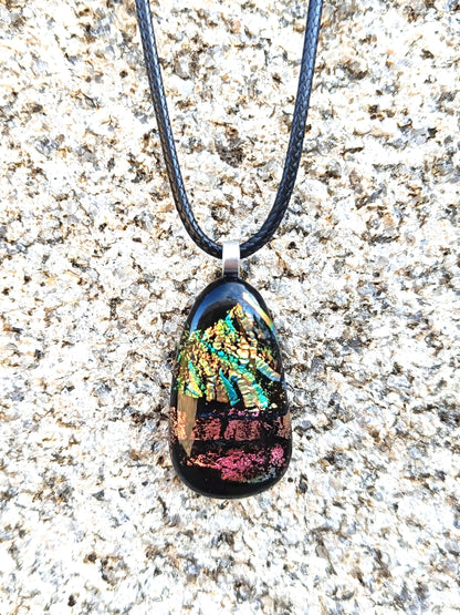 Fused glass pendant necklace with dichroic, iridescent greens, golds and pinks on black glass; corded, handmade jewellery.
