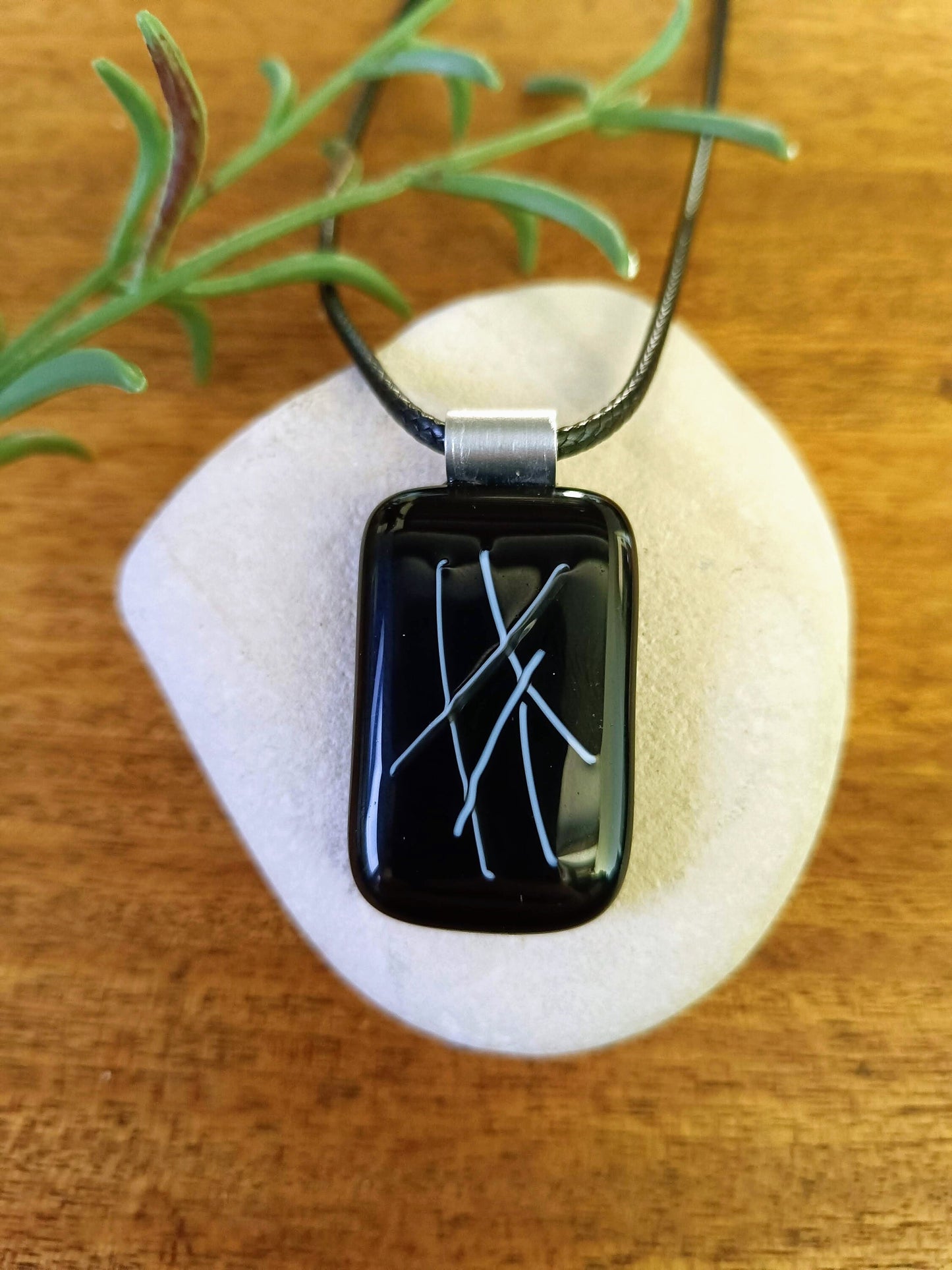 black glass pendant on a cord