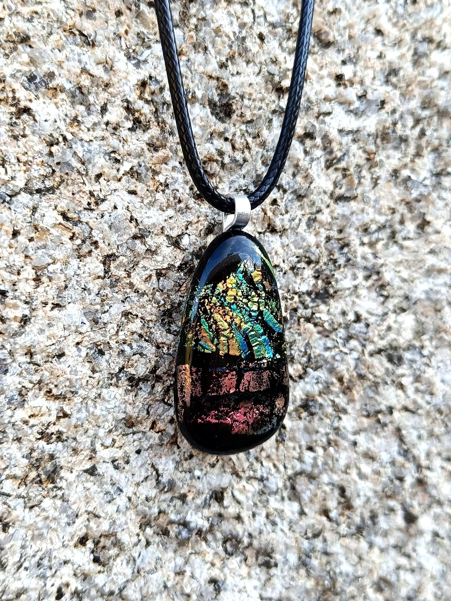 Fused glass pendant necklace with dichroic, iridescent greens, golds and pinks on black glass; corded, handmade jewellery.