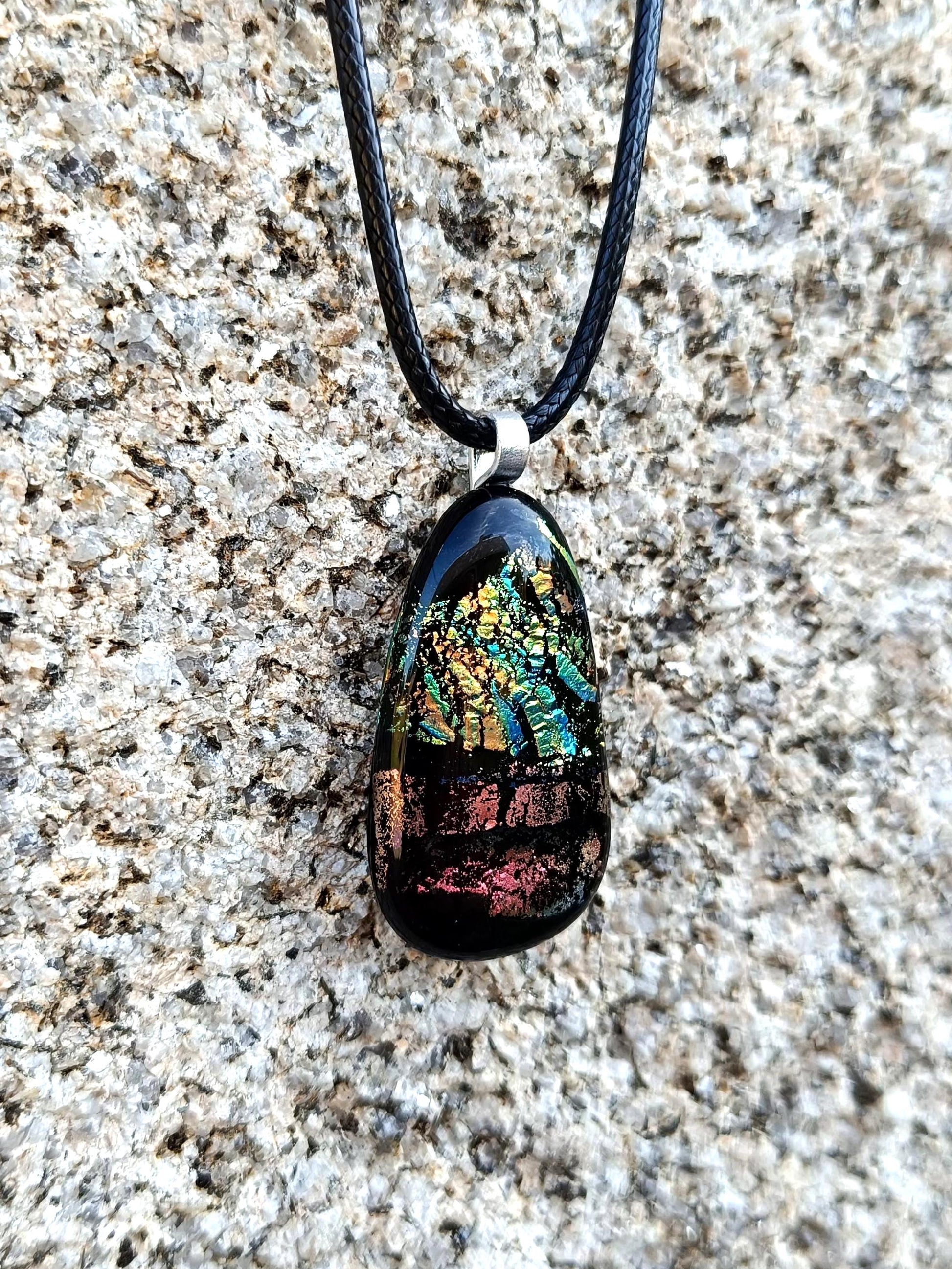 Fused glass pendant necklace with dichroic, iridescent greens, golds and pinks on black glass; corded, handmade jewellery.