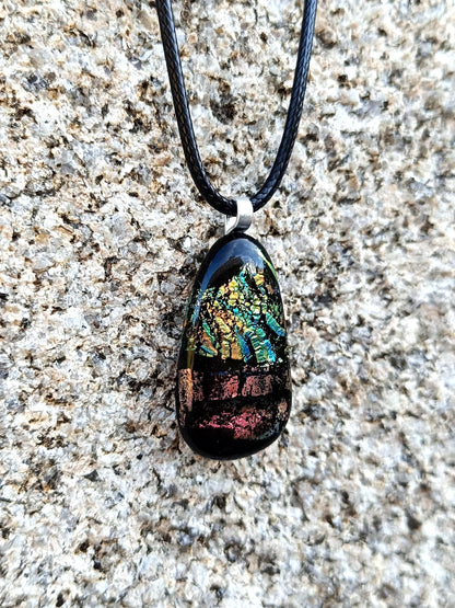 Fused glass pendant necklace with dichroic, iridescent greens, golds and pinks on black glass; corded, handmade jewellery.