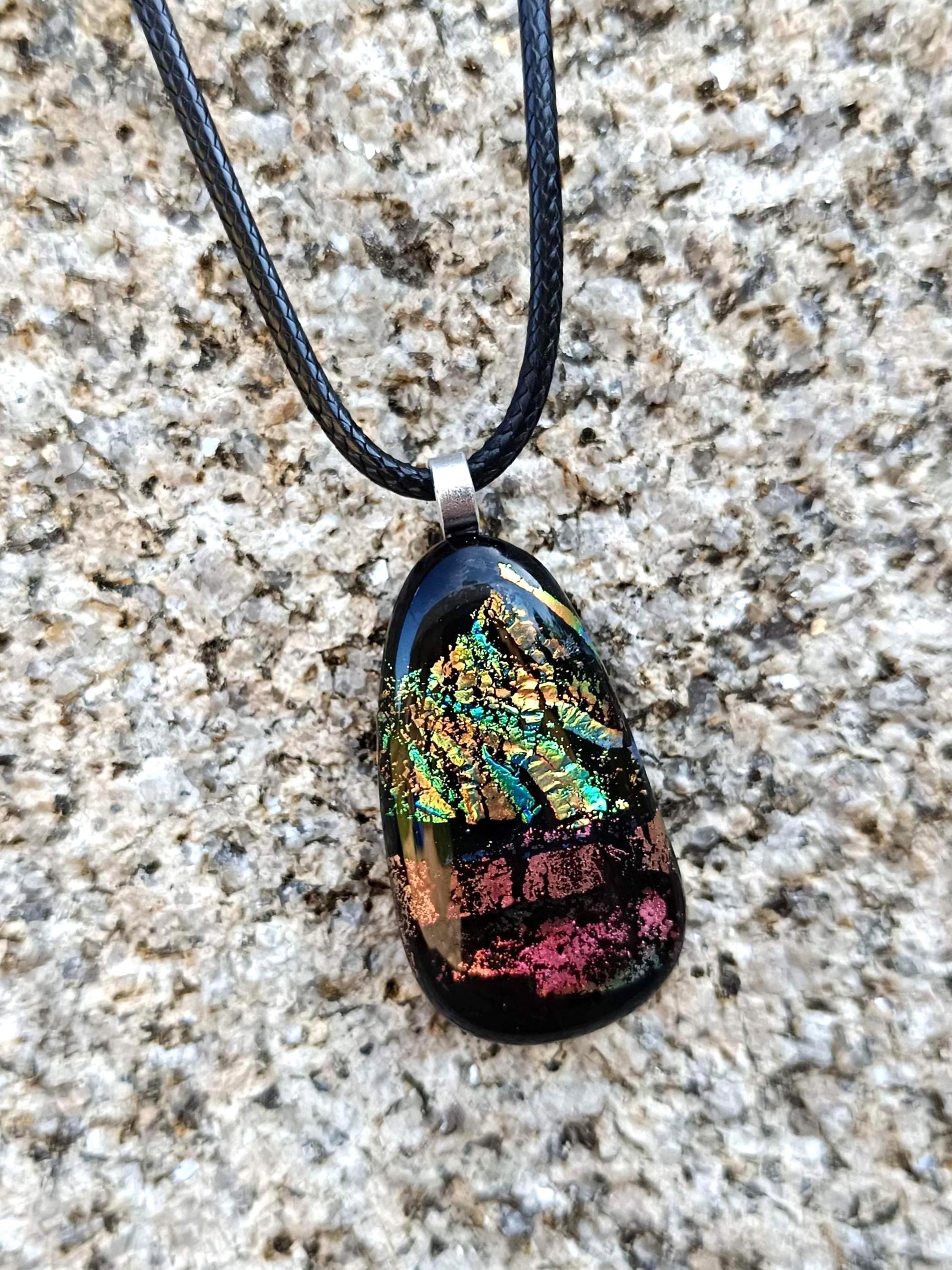 Fused glass pendant necklace with dichroic, iridescent greens, golds and pinks on black glass; corded, handmade jewellery.