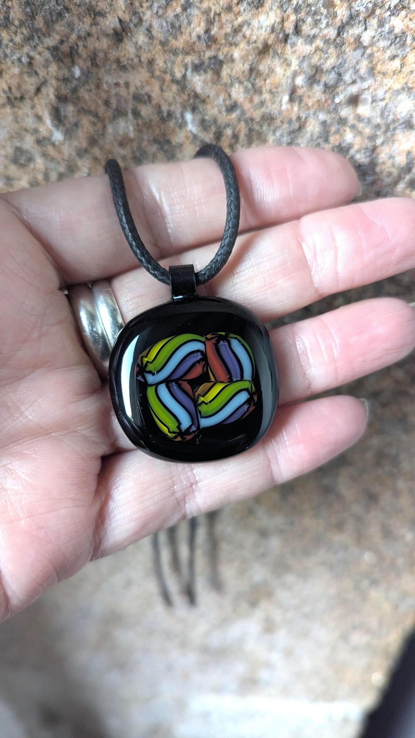 Fused glass pendant on black cord necklace; vibrant rainbow swirls, handmade one-of-a-kind letterbox gift.