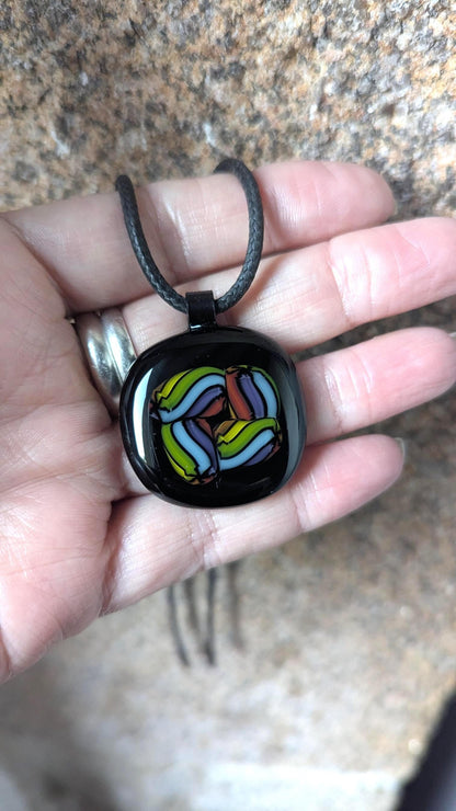Fused glass pendant on black cord necklace; vibrant rainbow swirls, handmade one-of-a-kind letterbox gift.