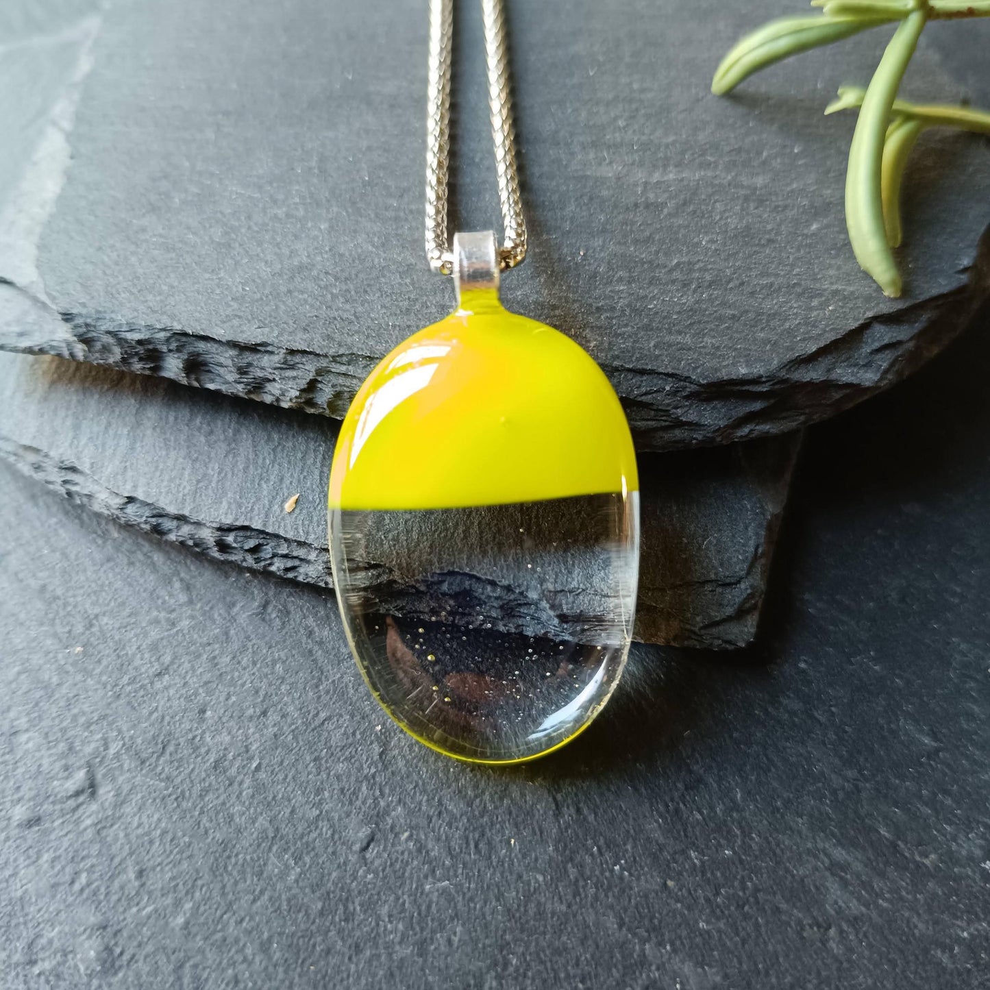 Handcrafted lime green and clear fused glass oval pendant necklace on a silver chain.