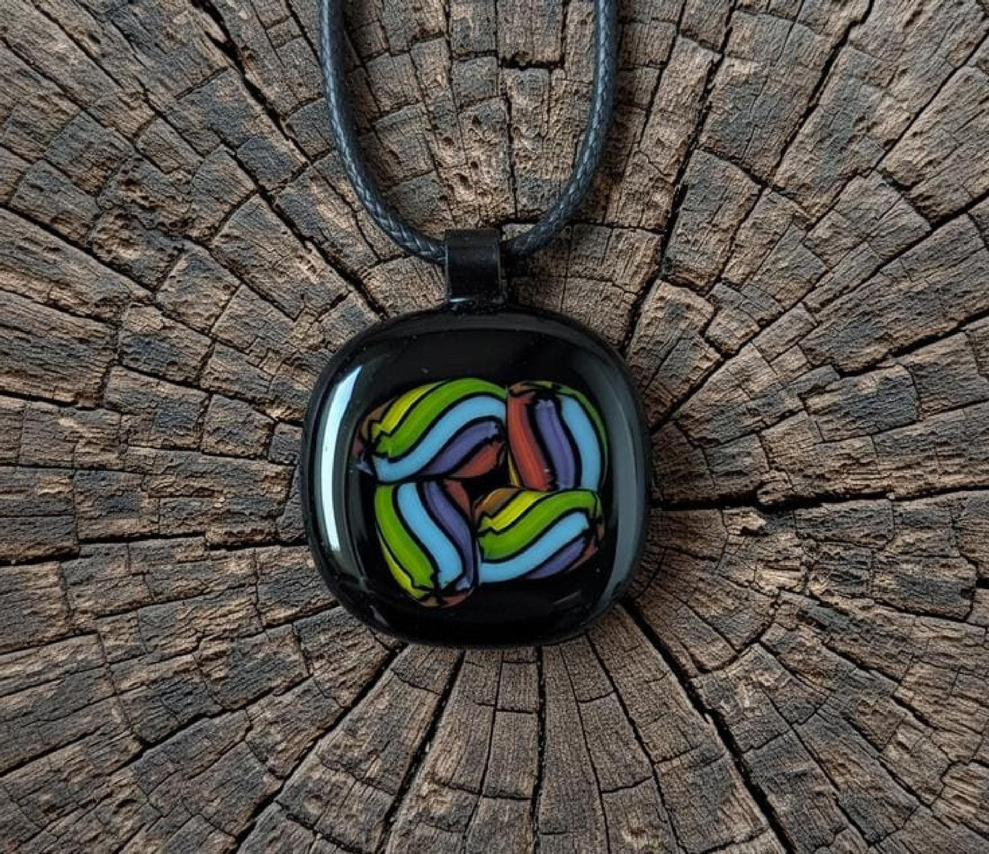 Fused glass pendant on black cord necklace; vibrant rainbow swirls, handmade one-of-a-kind letterbox gift.