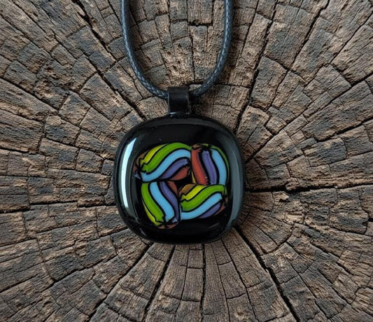 Fused glass pendant on black cord necklace; vibrant rainbow swirls, handmade one-of-a-kind letterbox gift.