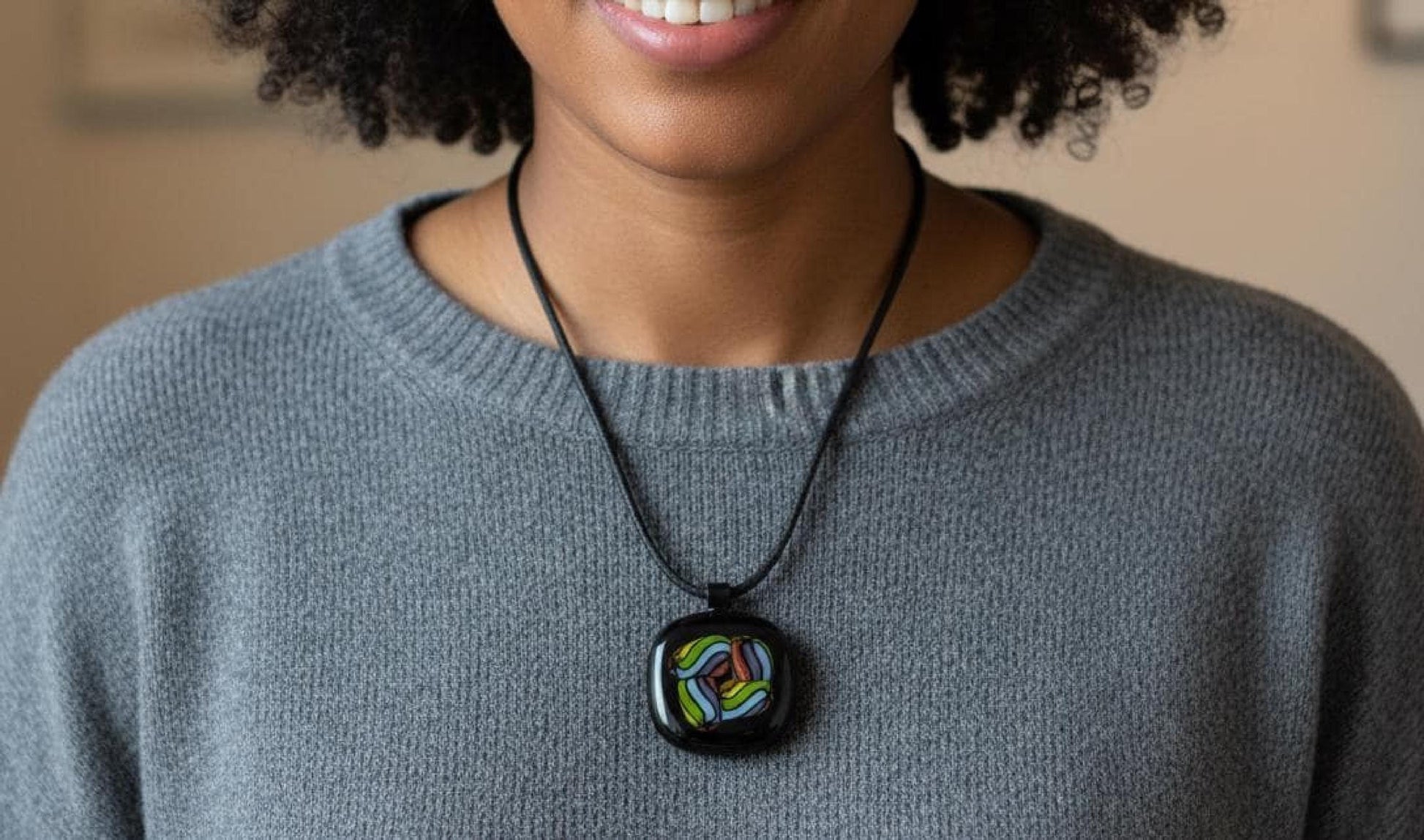 Fused glass pendant on black cord necklace; vibrant rainbow swirls, handmade one-of-a-kind letterbox gift.