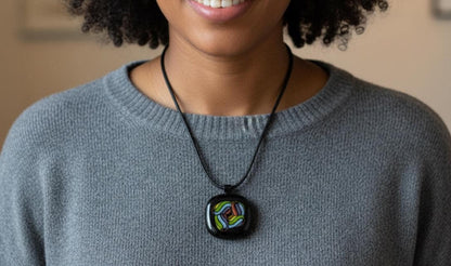 Fused glass pendant on black cord necklace; vibrant rainbow swirls, handmade one-of-a-kind letterbox gift.