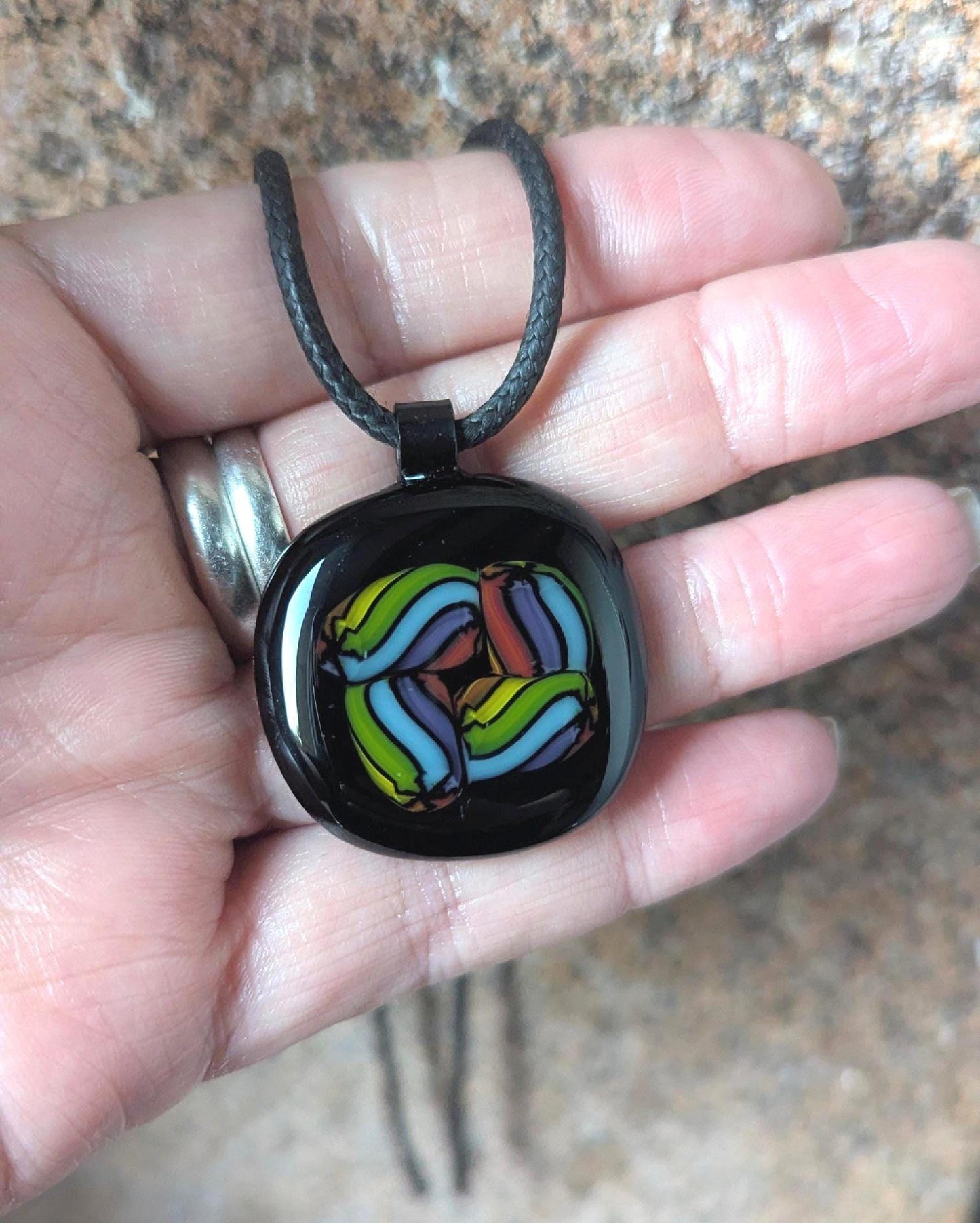 Fused glass pendant on black cord necklace; vibrant rainbow swirls, handmade one-of-a-kind letterbox gift.