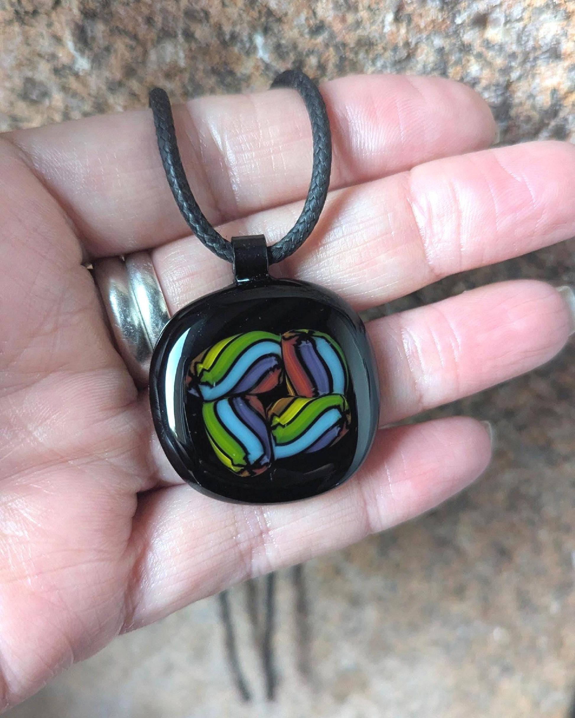 Fused glass pendant on black cord necklace; vibrant rainbow swirls, handmade one-of-a-kind letterbox gift.