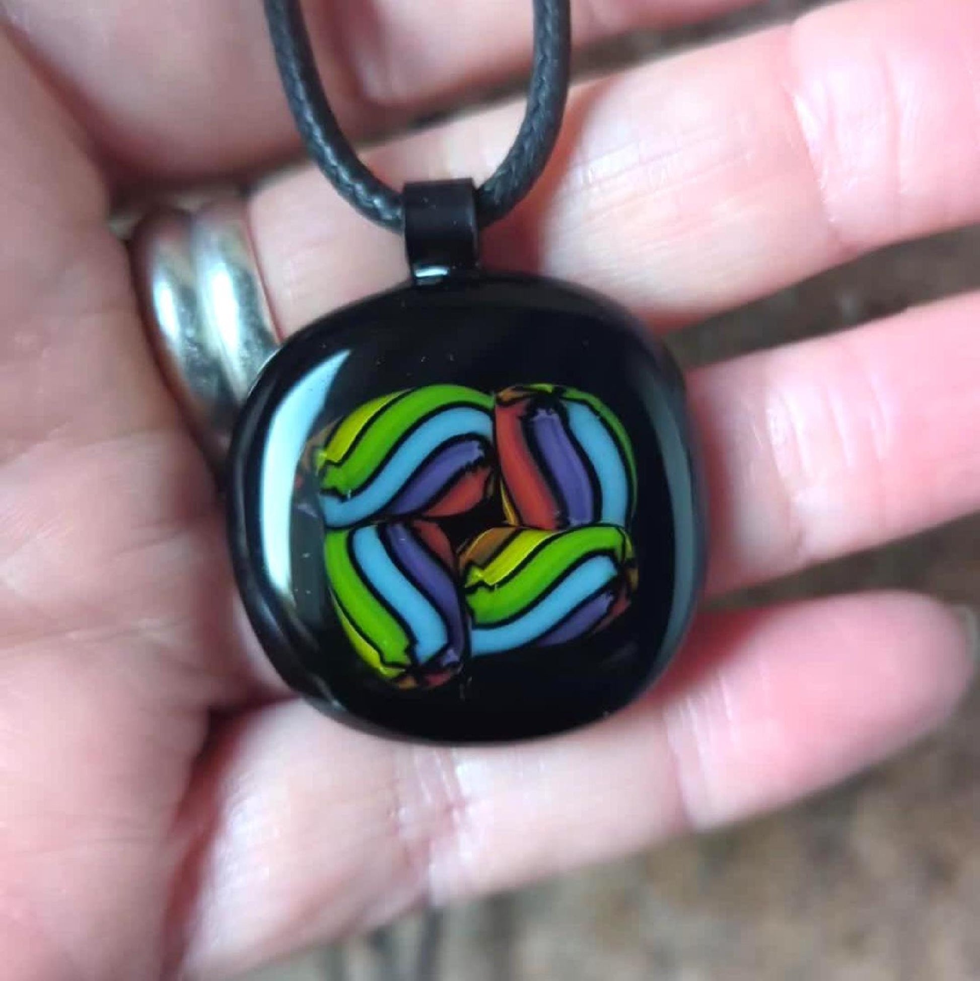 Fused glass pendant on black cord necklace; vibrant rainbow swirls, handmade one-of-a-kind letterbox gift.