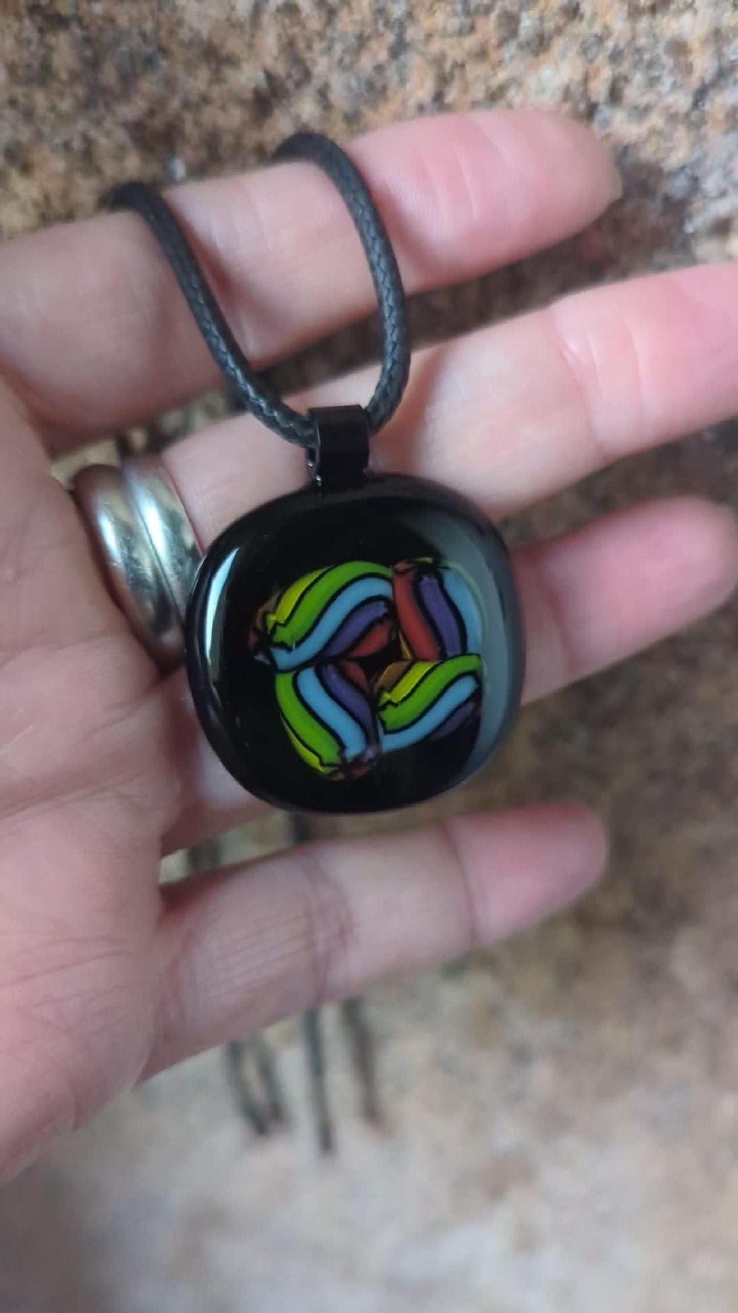 Fused glass pendant on black cord necklace; vibrant rainbow swirls, handmade one-of-a-kind letterbox gift.