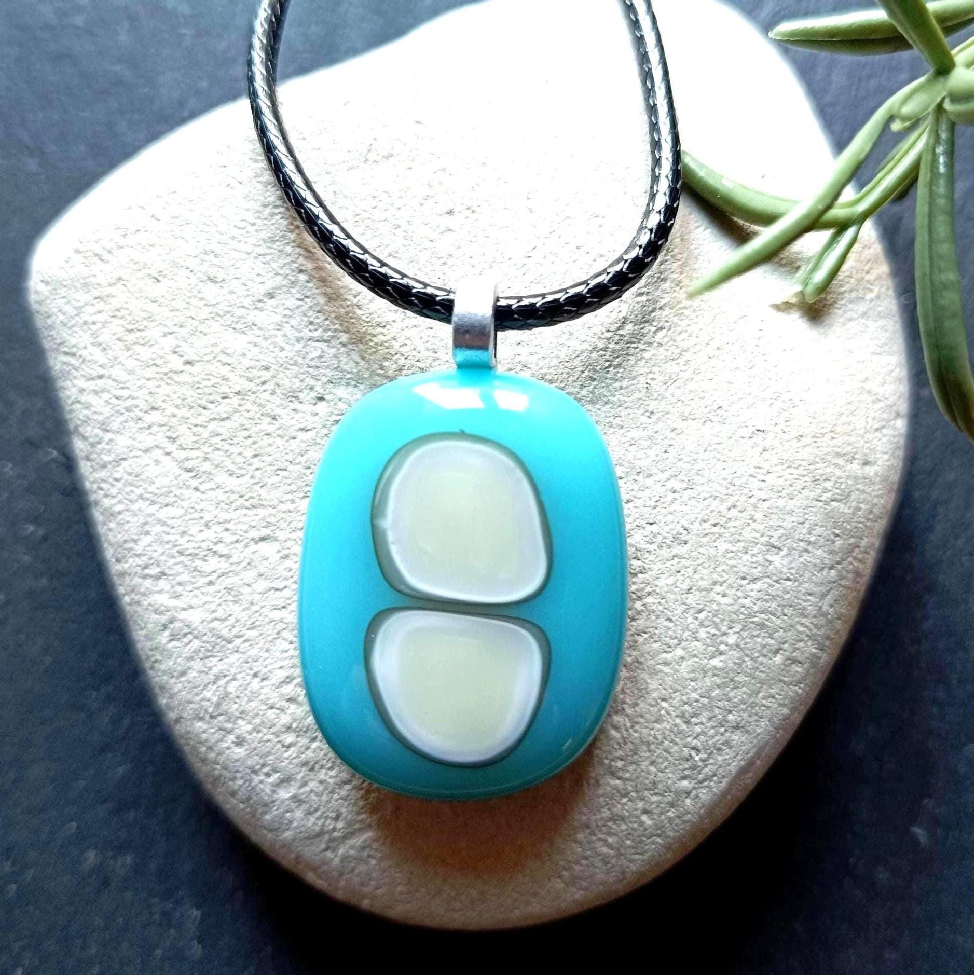 Turquoise fused glass pendant necklace with two pale inlay shapes on a black cord - handmade jewelry, one of a kind.