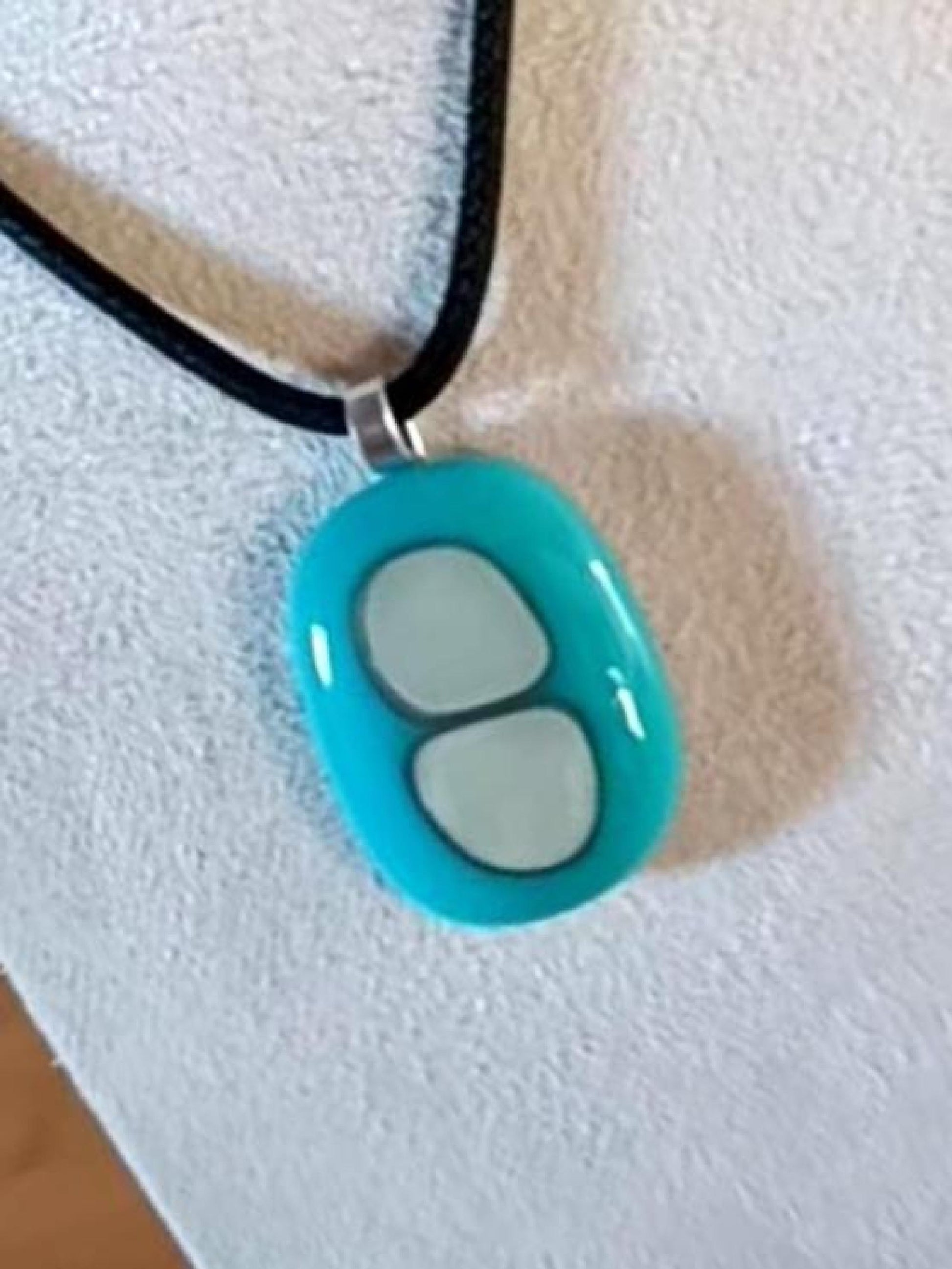 Turquoise fused glass pendant necklace with two pale inlay shapes on a black cord - handmade jewelry, one of a kind.