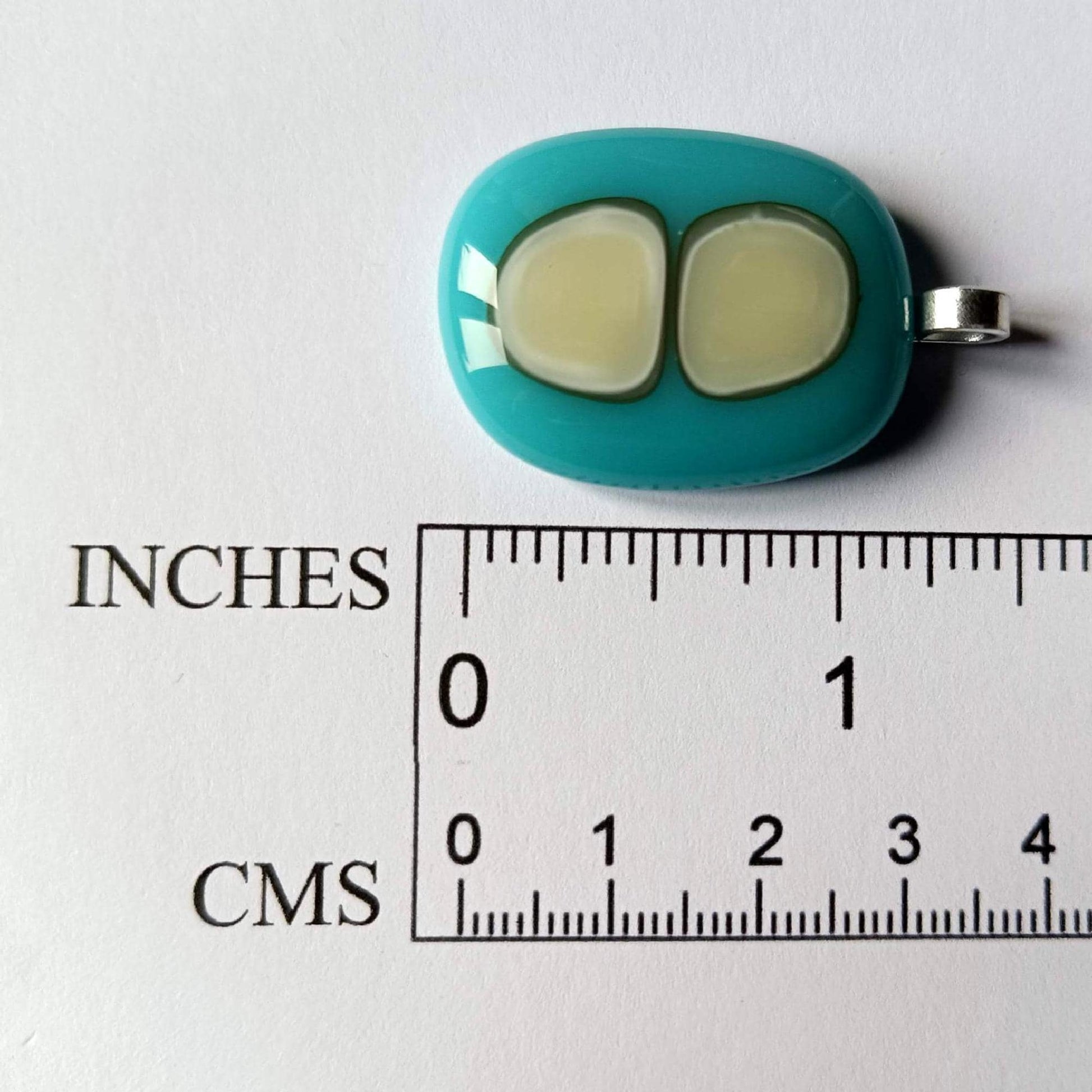 Turquoise fused glass pendant necklace with two pale inlay shapes on a black cord - handmade jewelry, one of a kind.