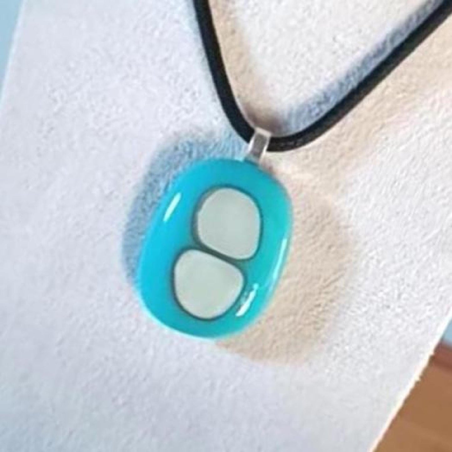 Turquoise fused glass pendant necklace with two pale inlay shapes on a black cord - handmade jewelry, one of a kind.