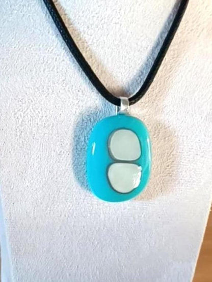 Turquoise fused glass pendant necklace with two pale inlay shapes on a black cord - handmade jewelry, one of a kind.